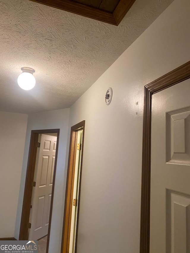 corridor with a textured ceiling