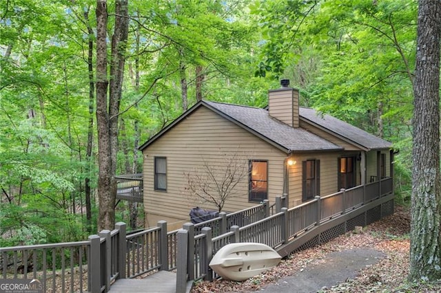 back of property with a wooden deck