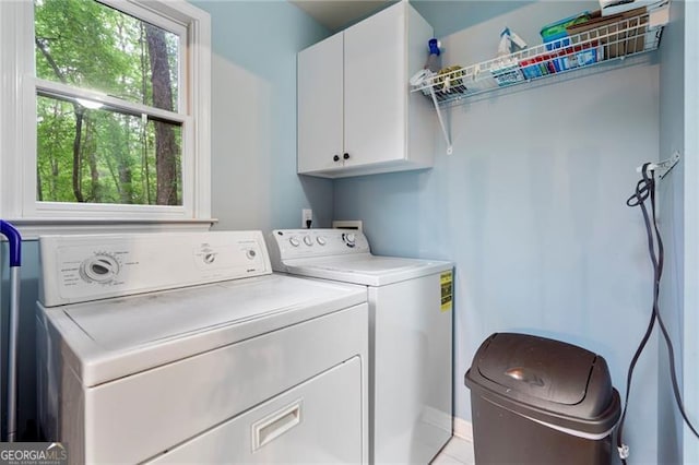 laundry area with cabinets and washing machine and dryer