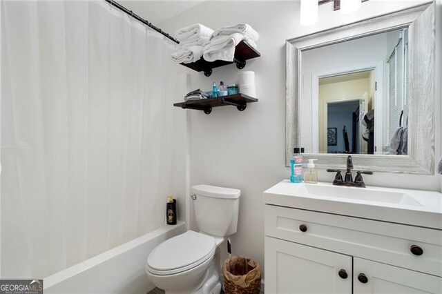 full bathroom with vanity, shower / bath combination with curtain, and toilet