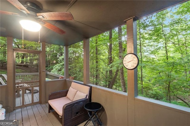 sunroom featuring ceiling fan