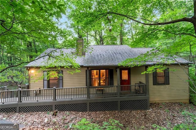 rear view of property featuring a deck