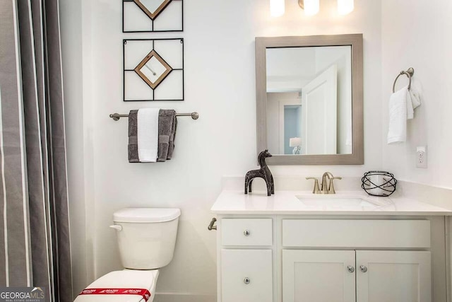 bathroom featuring vanity and toilet