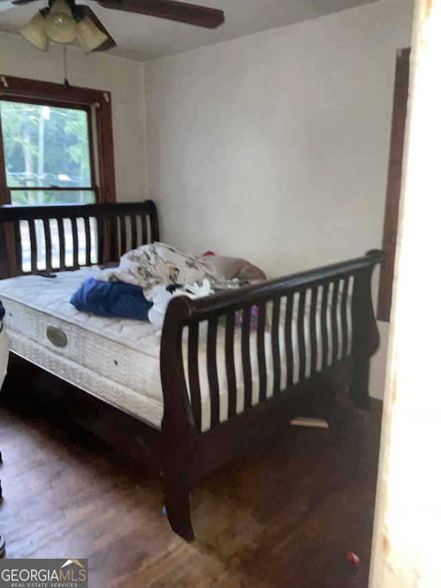 bedroom with hardwood / wood-style floors and ceiling fan