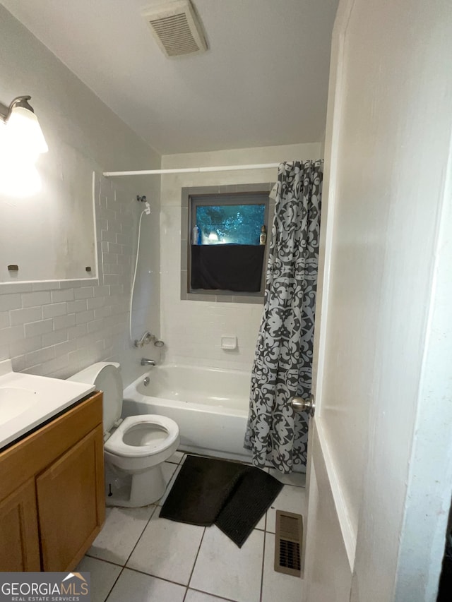 full bathroom with tile patterned flooring, tile walls, shower / bath combo, toilet, and vanity