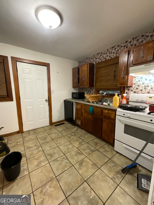 kitchen with decorative backsplash, light tile patterned flooring, black appliances, and extractor fan