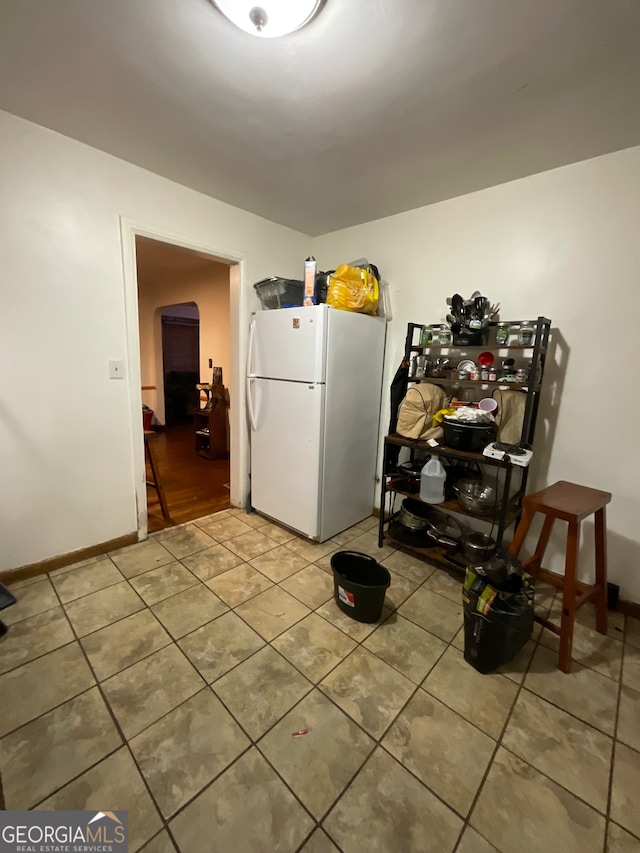 interior space featuring tile patterned floors and white refrigerator