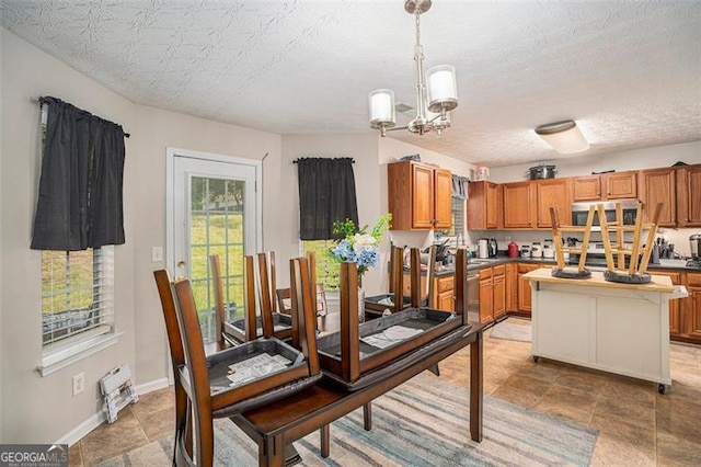 dining area with a chandelier and a textured ceiling