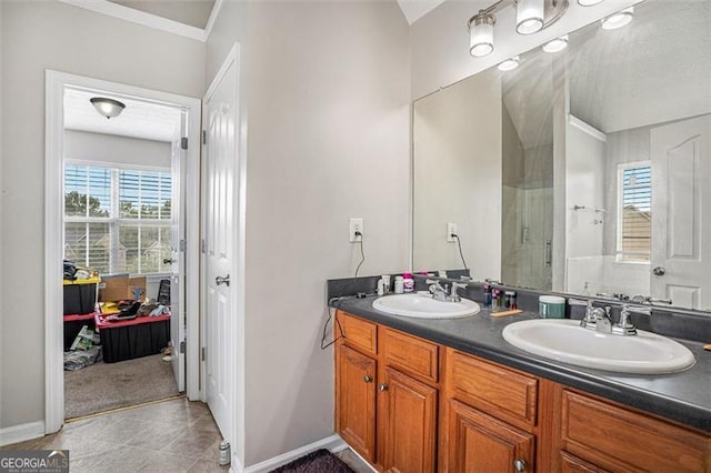 bathroom featuring tile patterned flooring, vanity, and crown molding