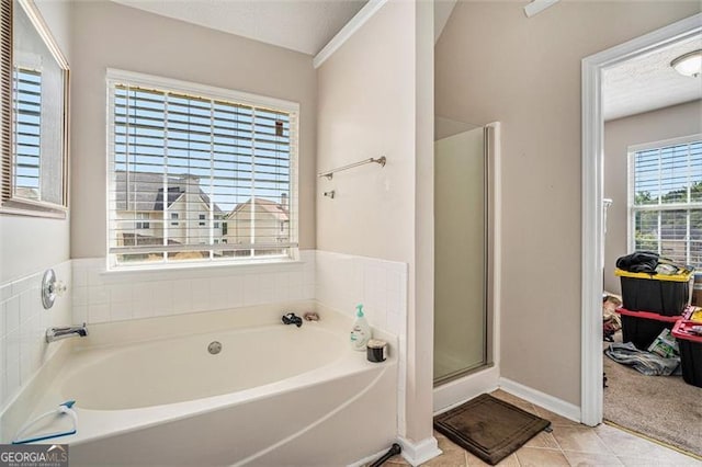 bathroom featuring tile patterned flooring and shower with separate bathtub