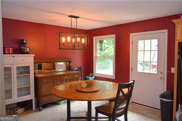 dining area featuring a healthy amount of sunlight and a notable chandelier