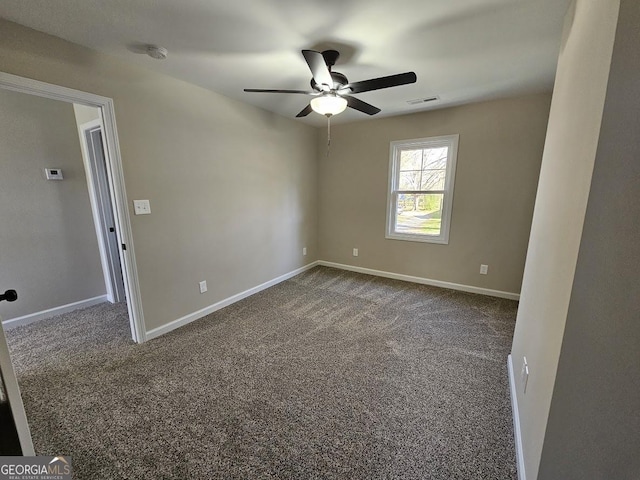 carpeted spare room featuring ceiling fan