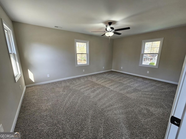 carpeted spare room with ceiling fan