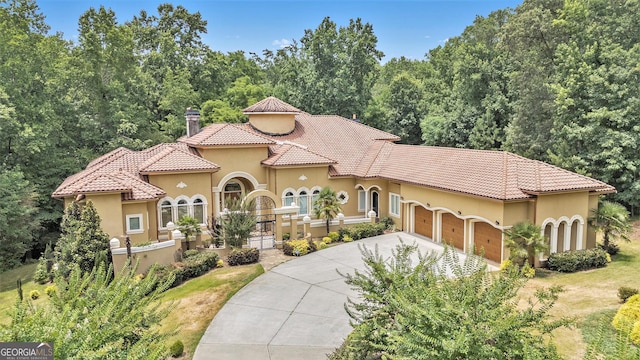 mediterranean / spanish-style home featuring a garage