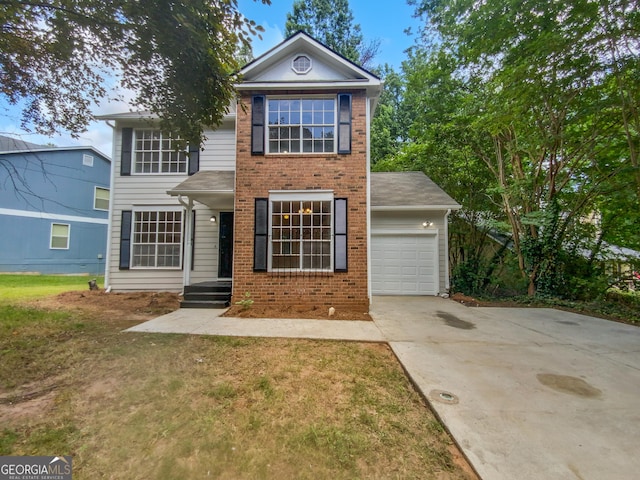 view of front of property with a front yard and a garage