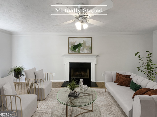 living room featuring crown molding, ceiling fan, and a textured ceiling