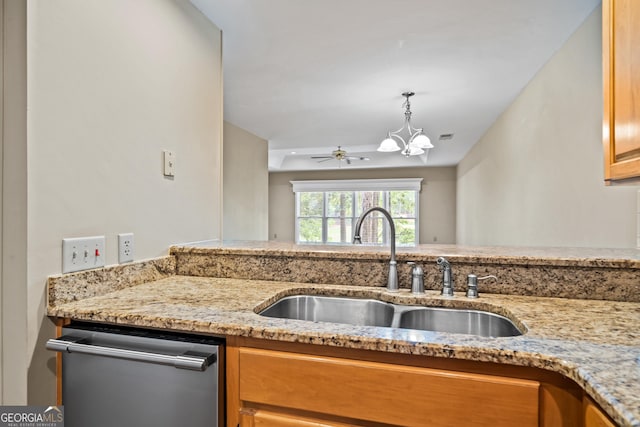 kitchen with ceiling fan with notable chandelier, sink, stainless steel dishwasher, light stone countertops, and decorative light fixtures