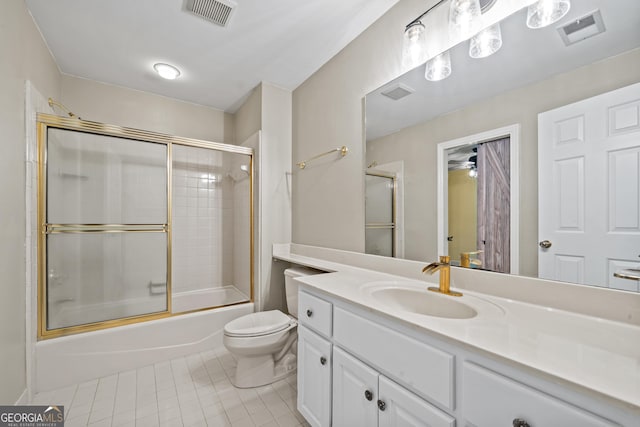 full bathroom with tile patterned floors, vanity, combined bath / shower with glass door, and toilet