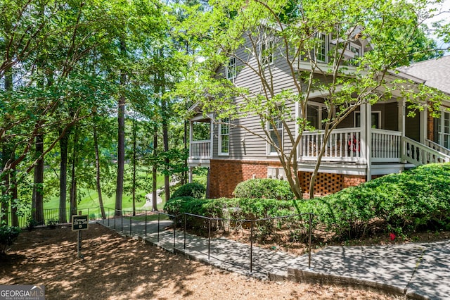 view of side of property featuring covered porch