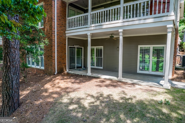 exterior space with ceiling fan and a balcony