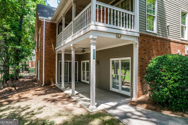 exterior space with a balcony, ceiling fan, and a patio area