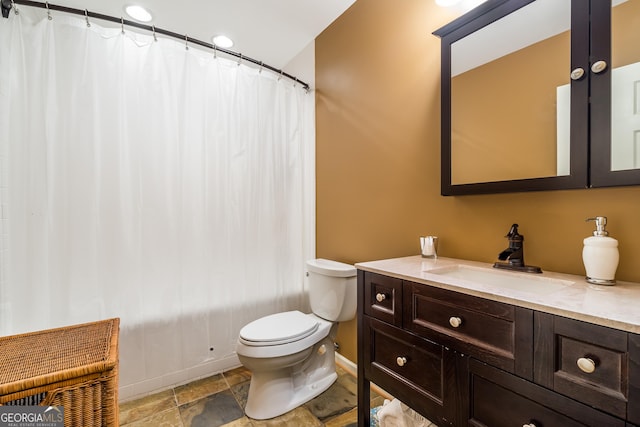 bathroom featuring vanity and toilet