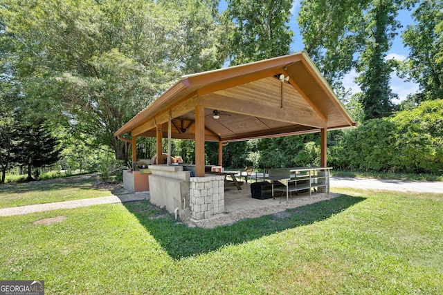 view of home's community with a gazebo, a patio, and a lawn