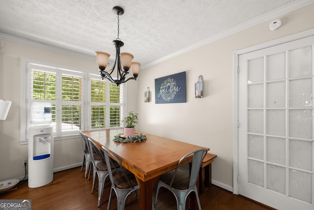 dining space featuring dark hardwood / wood-style floors, crown molding, and a notable chandelier