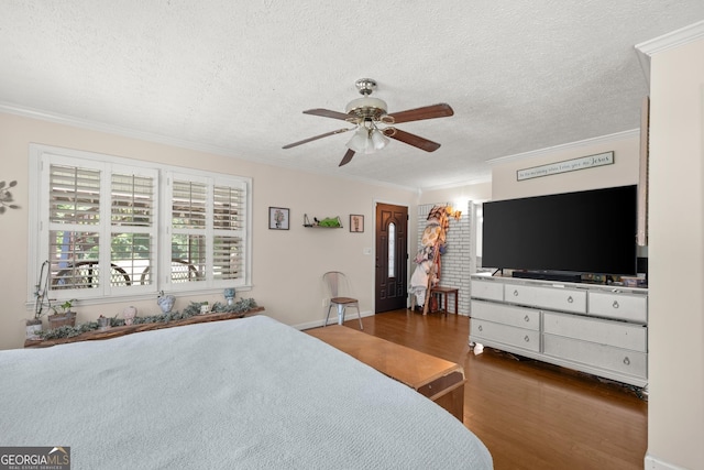 bedroom featuring a textured ceiling, ceiling fan, dark hardwood / wood-style floors, and ornamental molding