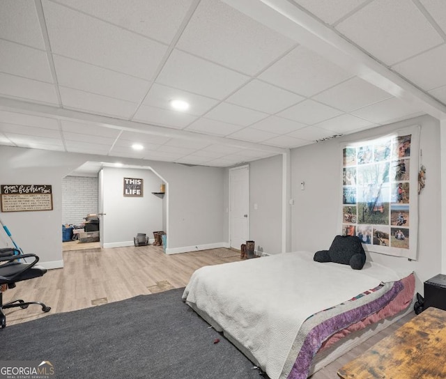 bedroom featuring a paneled ceiling and hardwood / wood-style flooring