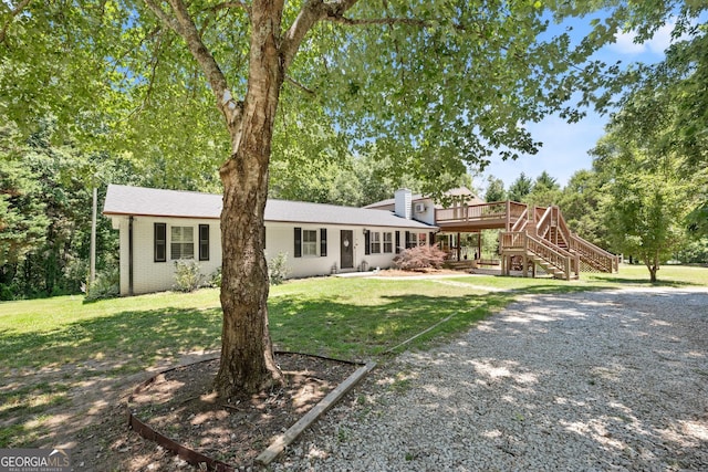 exterior space with a deck and a lawn