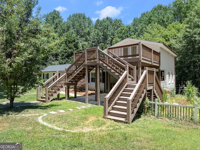 view of playground with a lawn and a deck