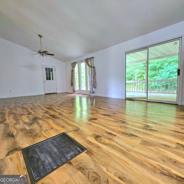 unfurnished living room featuring ceiling fan, hardwood / wood-style floors, and lofted ceiling