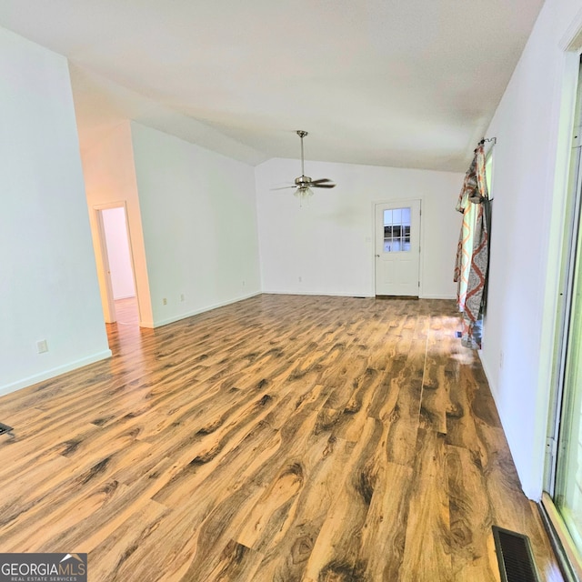 unfurnished living room featuring hardwood / wood-style flooring, lofted ceiling, and ceiling fan