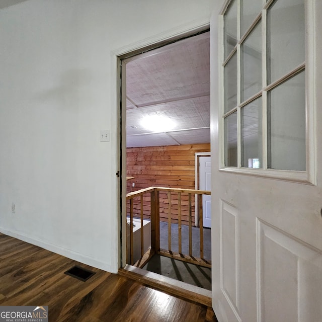 interior space featuring hardwood / wood-style flooring and wood walls