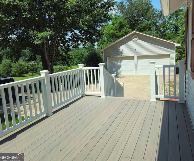 deck with a garage and an outdoor structure