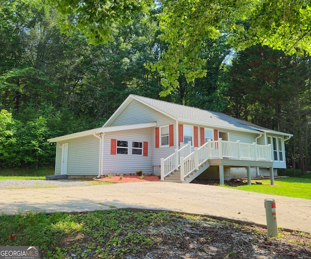 single story home with a wooden deck