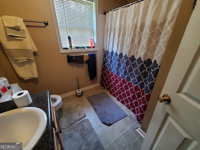 bathroom featuring curtained shower, a wealth of natural light, vanity, and tile patterned flooring