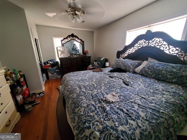 bedroom with ceiling fan and dark hardwood / wood-style floors