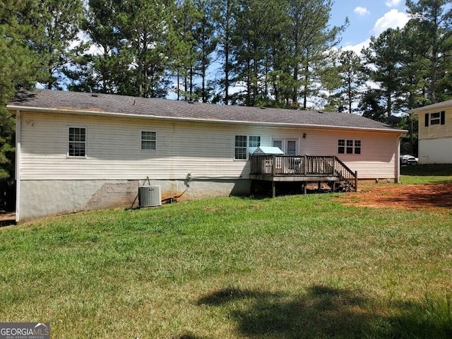 back of house with a wooden deck, a yard, and central air condition unit