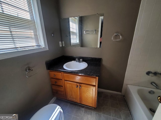 bathroom featuring toilet, vanity, and tile patterned flooring