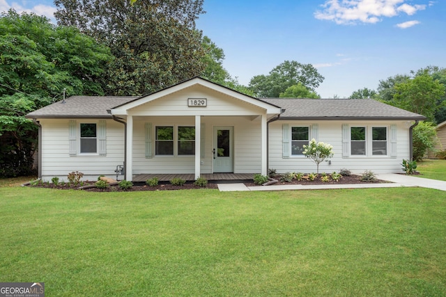 ranch-style house with a porch and a front lawn