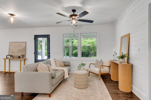 living room featuring ceiling fan, wood-type flooring, and ornamental molding