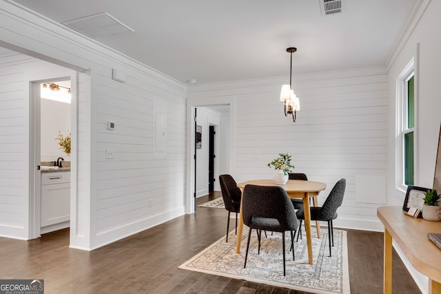 dining space featuring dark hardwood / wood-style floors and crown molding