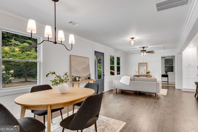 dining room with ceiling fan, wood-type flooring, and crown molding