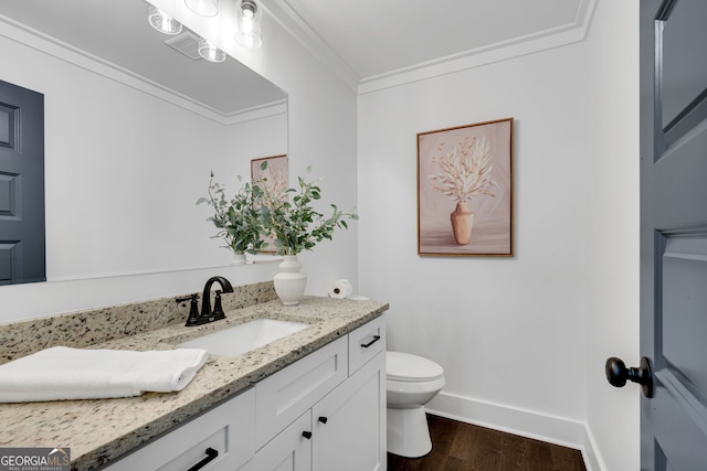 bathroom with hardwood / wood-style floors, vanity, toilet, and ornamental molding