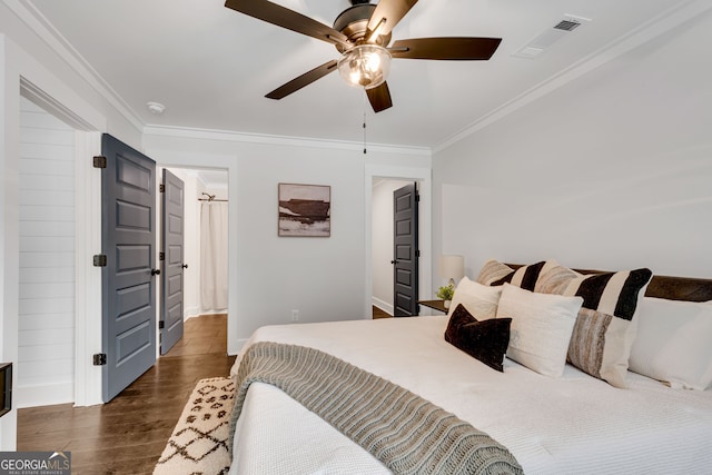 bedroom with ceiling fan, crown molding, and dark wood-type flooring