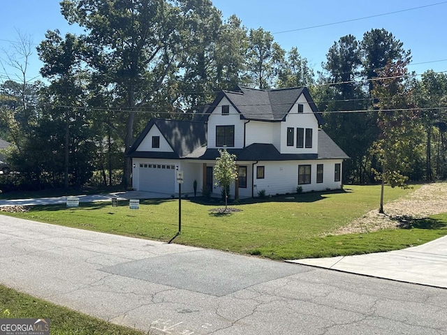 view of front of home with a garage and a front lawn