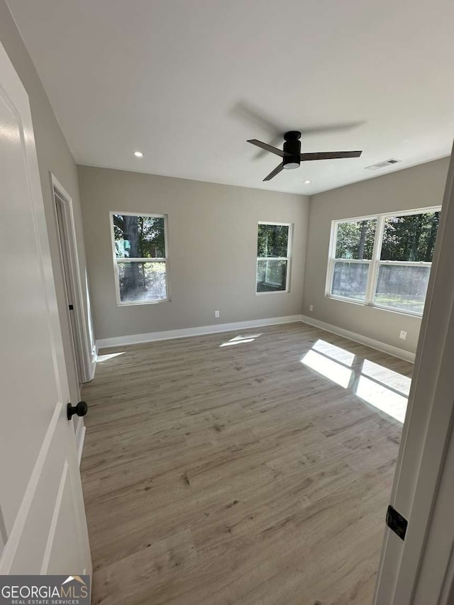 unfurnished room with ceiling fan and light hardwood / wood-style floors