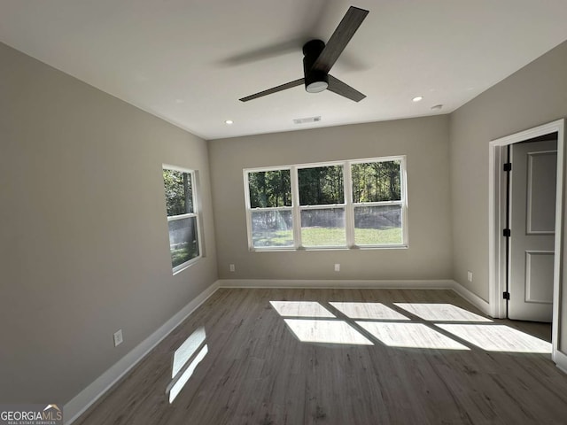 empty room with hardwood / wood-style flooring and ceiling fan